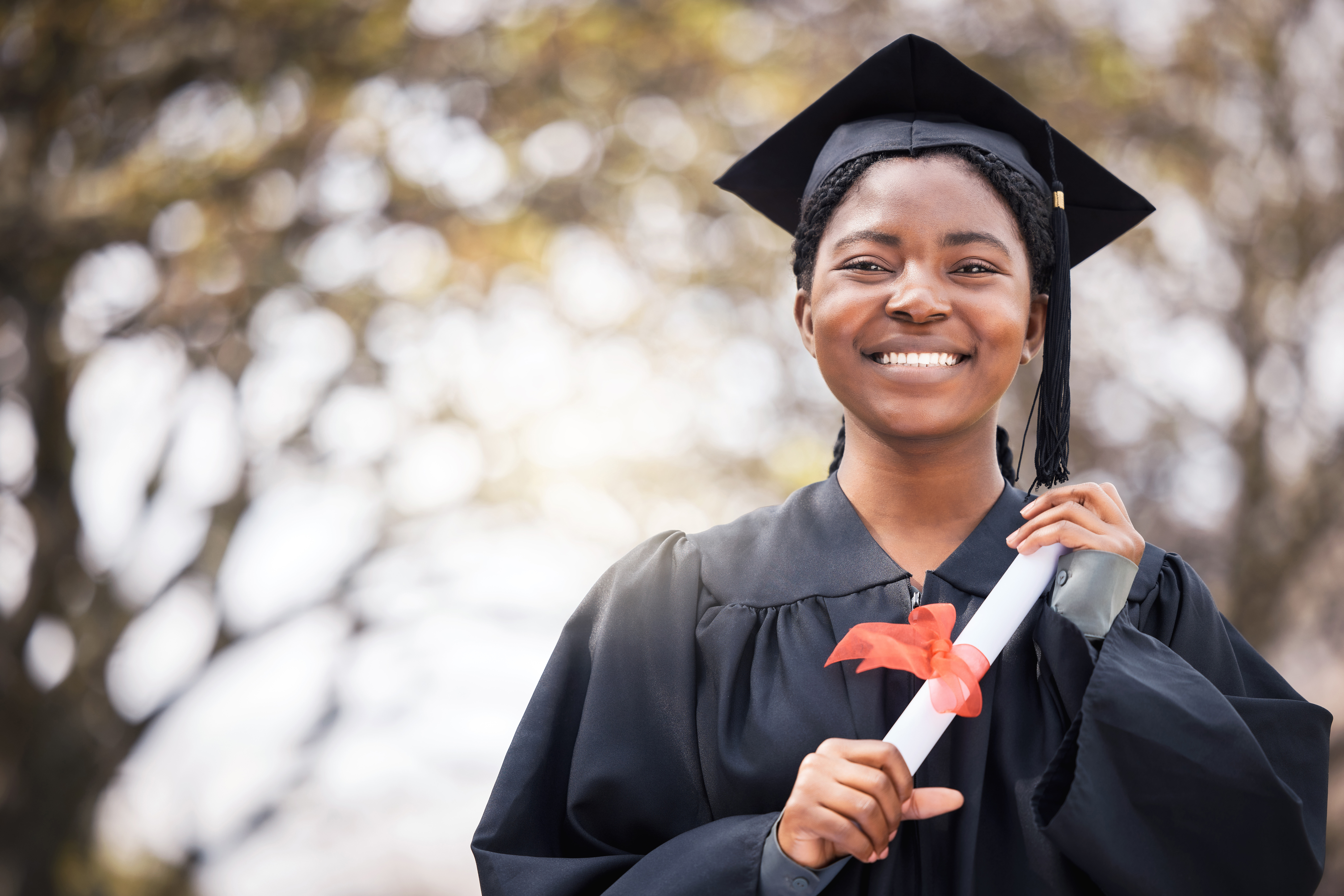 Graduate smiling in cap and gown